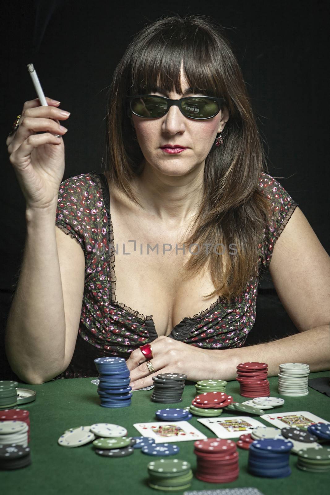 Attractive woman playing a game of poker