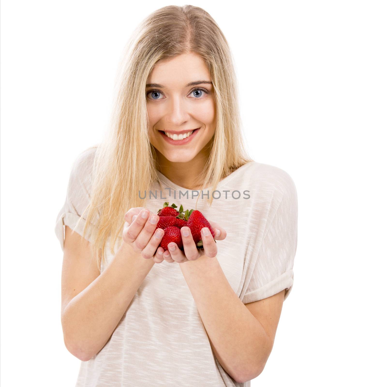 Beautiful blonde woman smiling and holding strawberries, isolated over white background