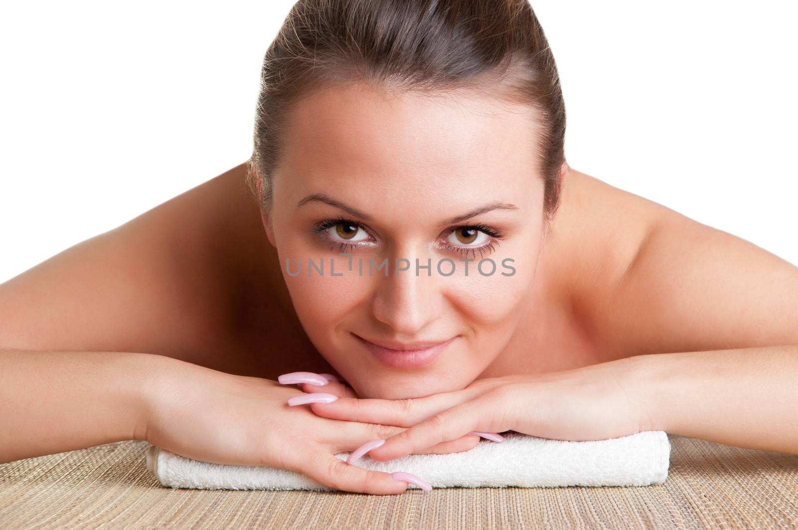 Young woman lying in a spa ready to get a massage isolated in white