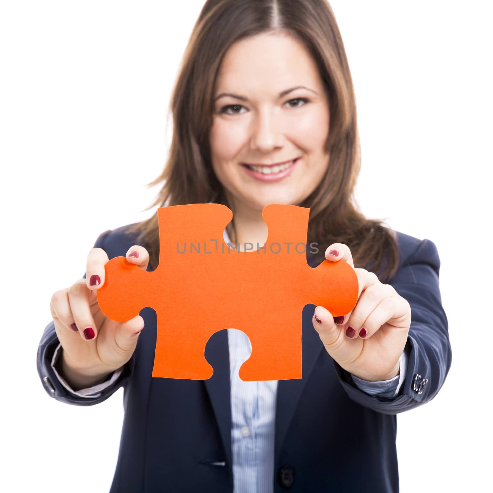 Business woman holding a puzzle piece, isolated over white