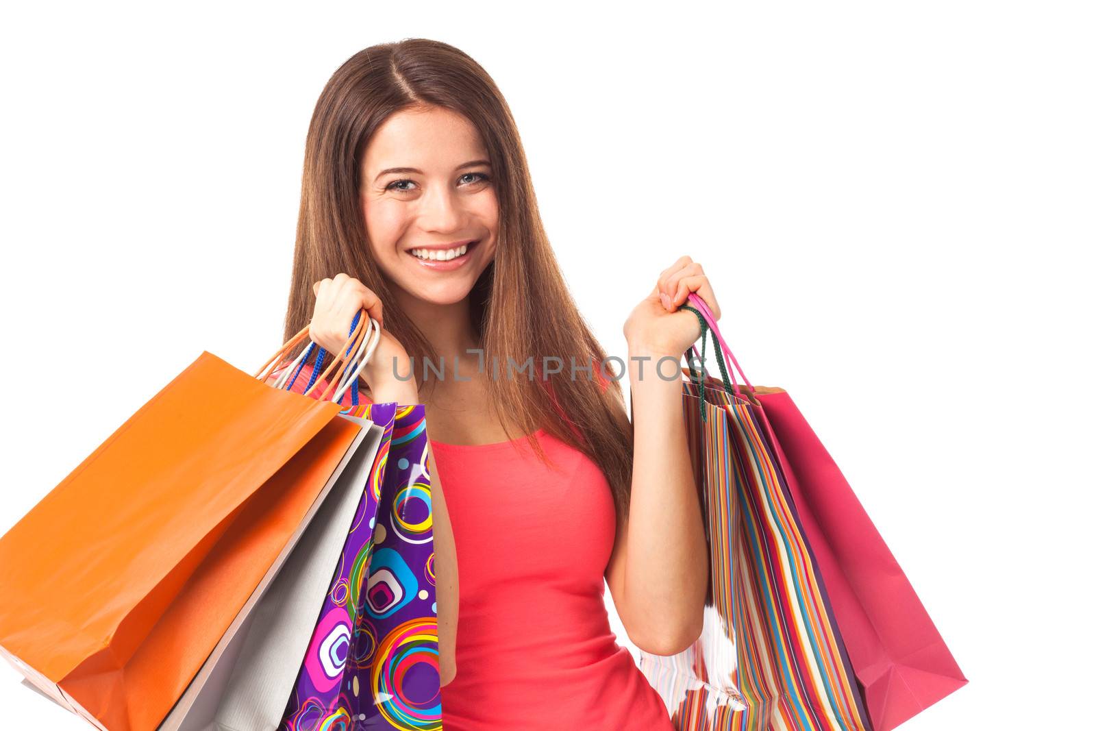 Young woman shopping and looking happy, isolated on white