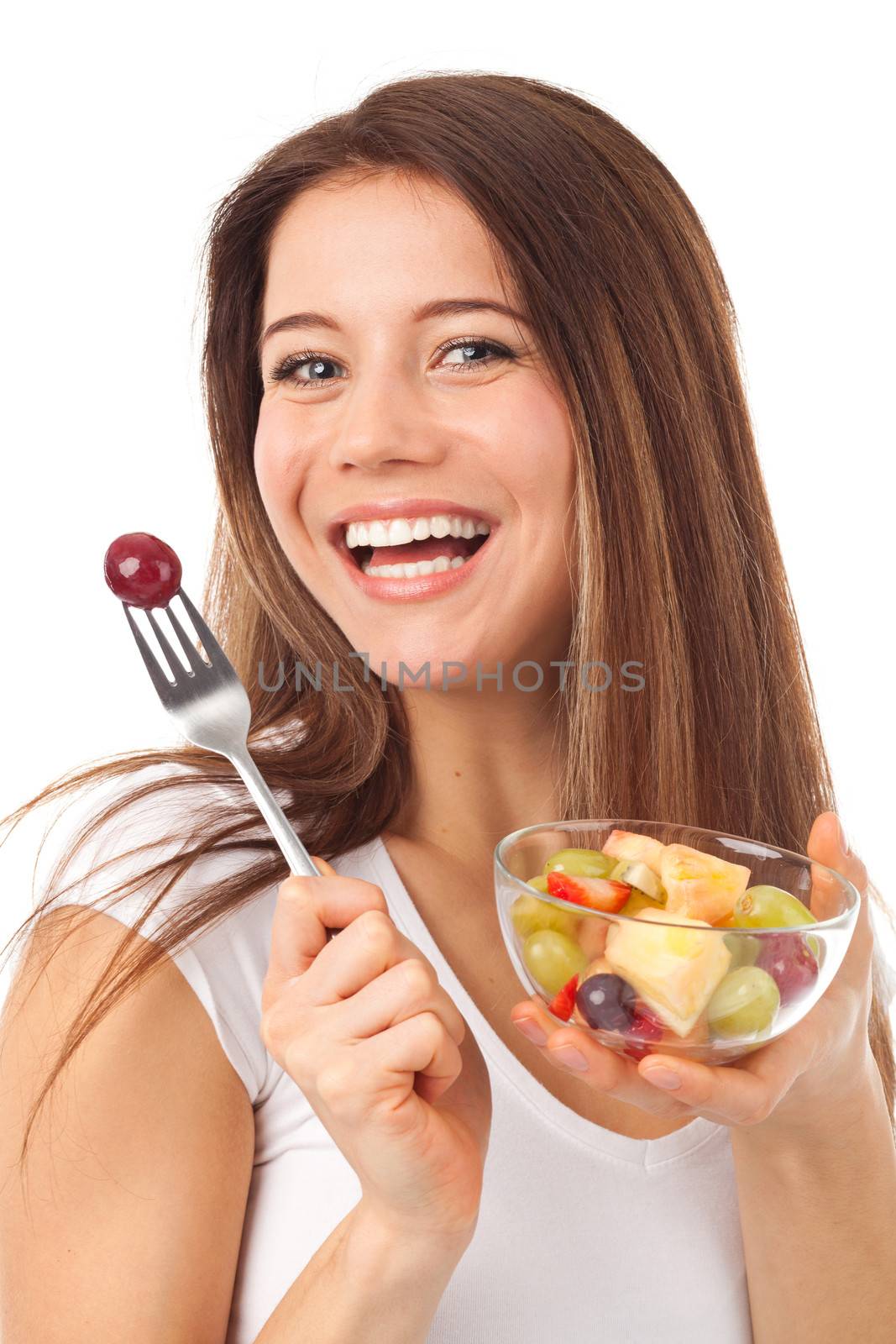 Beautiful woman eating fruits and smiling, isolated on white