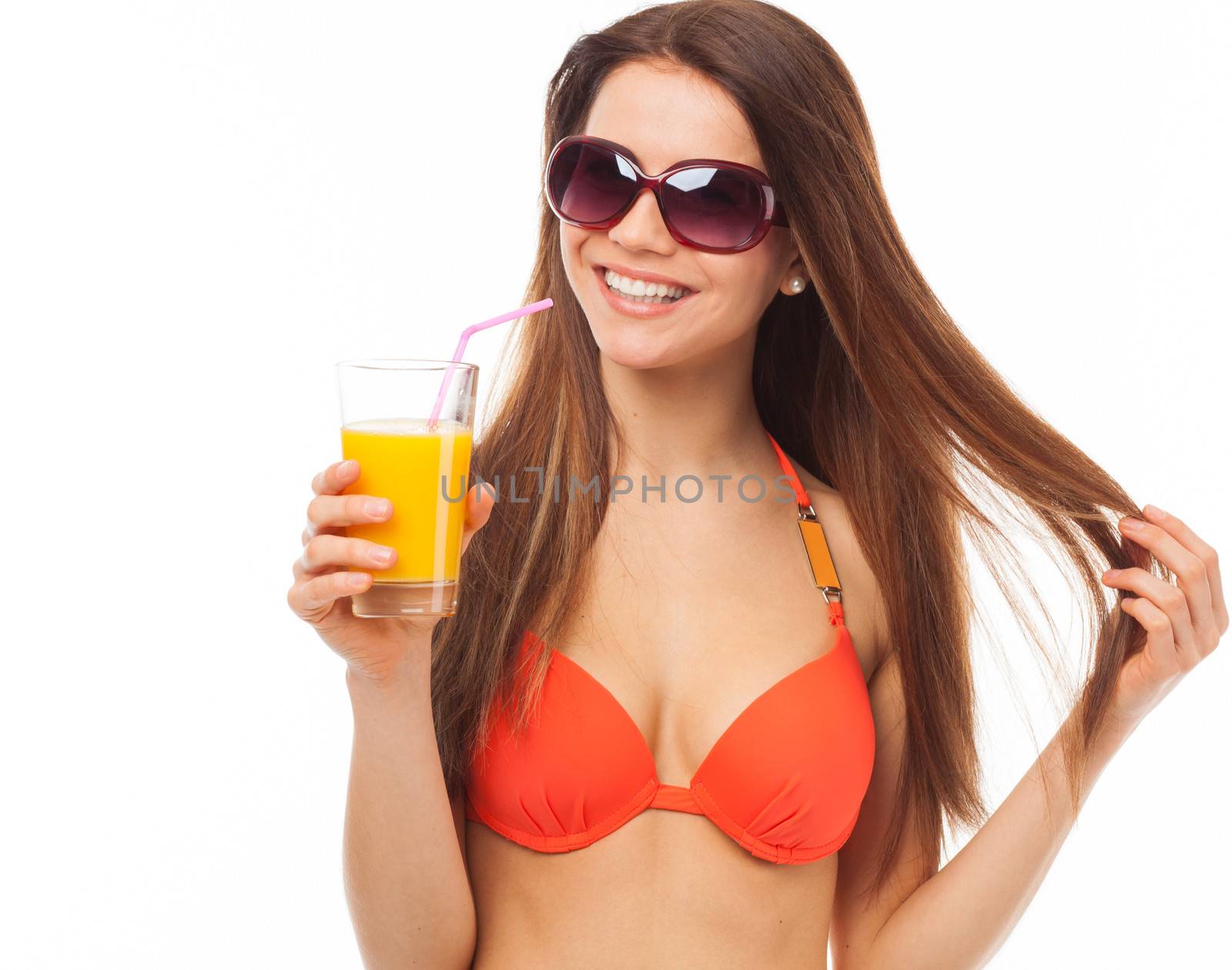 Young smiling woman with sunglasses drinks orange juice in summer, isolated on white