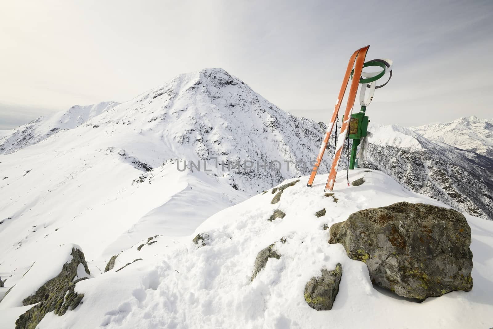 Pair of back country ski on the summit with amazing view on the alpine arc