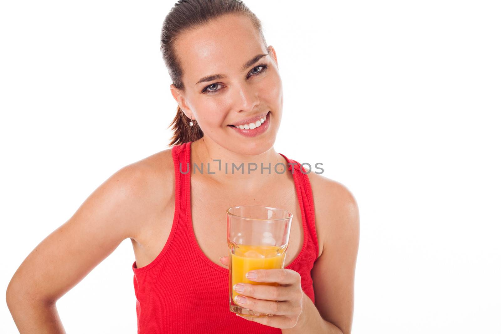 Portrait of a woman drinking an orange juice and smiling, isolated on white