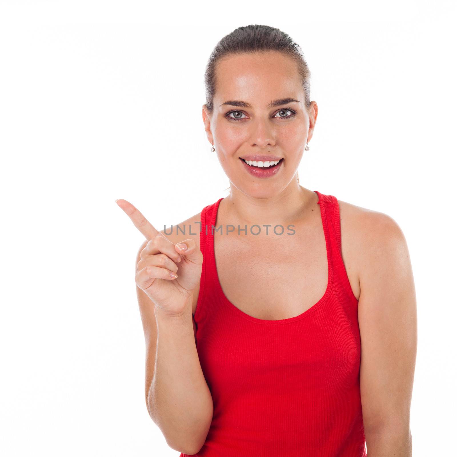 Cute young woman showing something with her finger, copyspace, isolated on white 