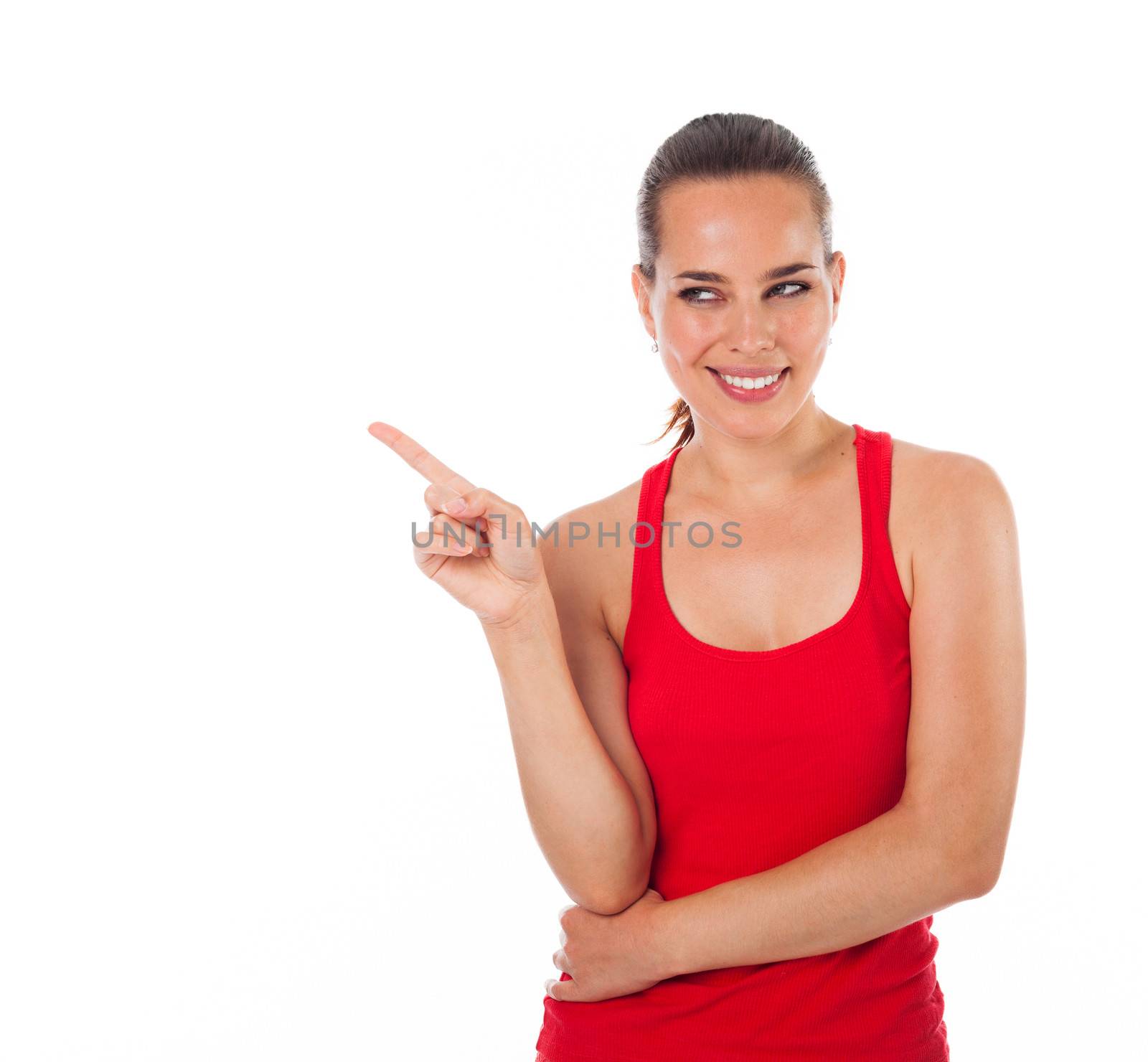 Young smiling woman showing something with her finger, copyspace, isolated on white 
