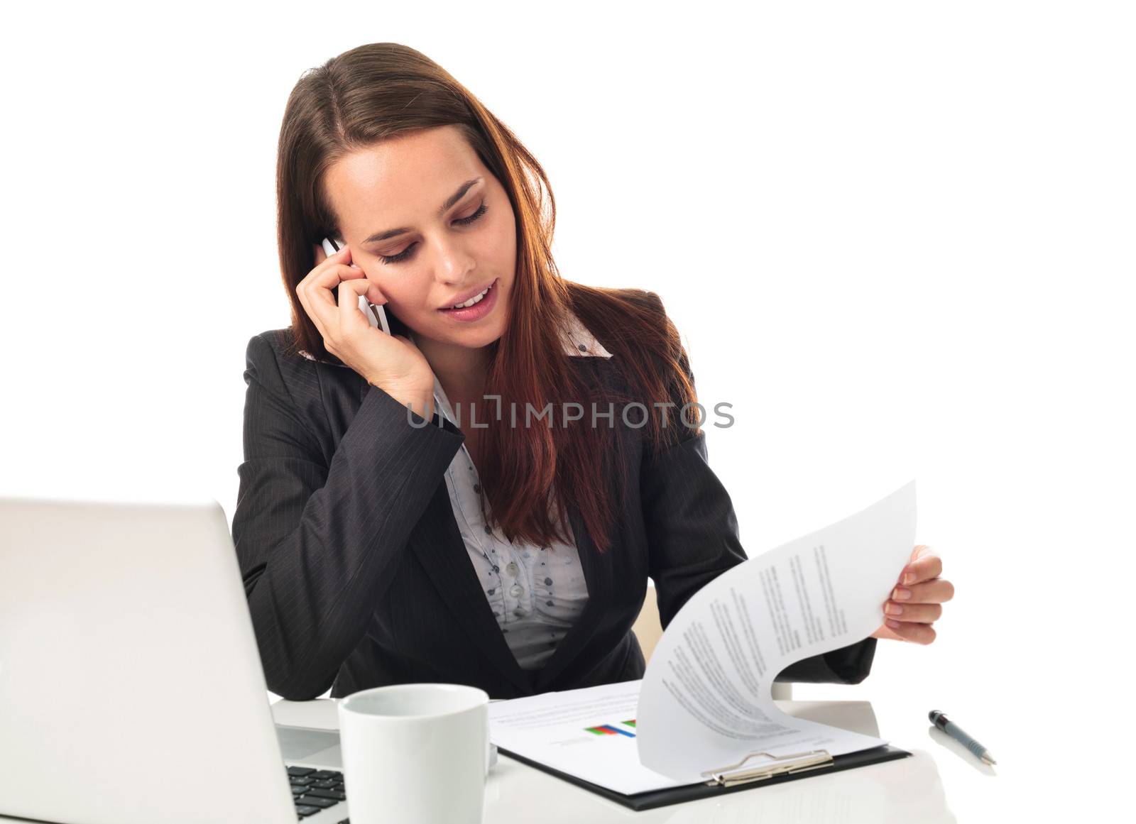 Young business woman on the phone, working in front a laptop, isolated on white 