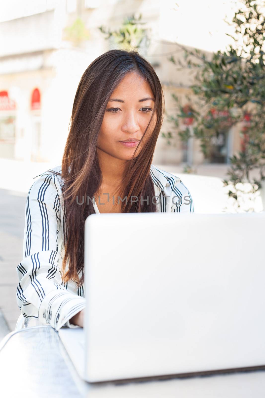Beautiful asian girl using a laptop, businesswoman or student