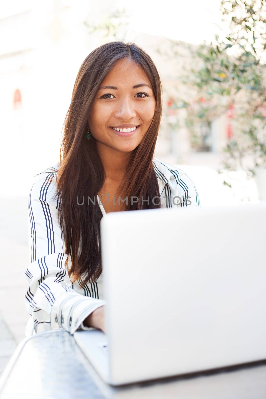 Beautiful asian businesswoman or student using a laptop