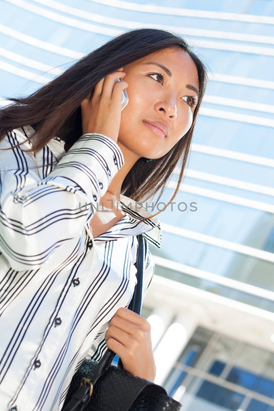 Close up portrait of a beautiful asian businesswoman using mobile phone