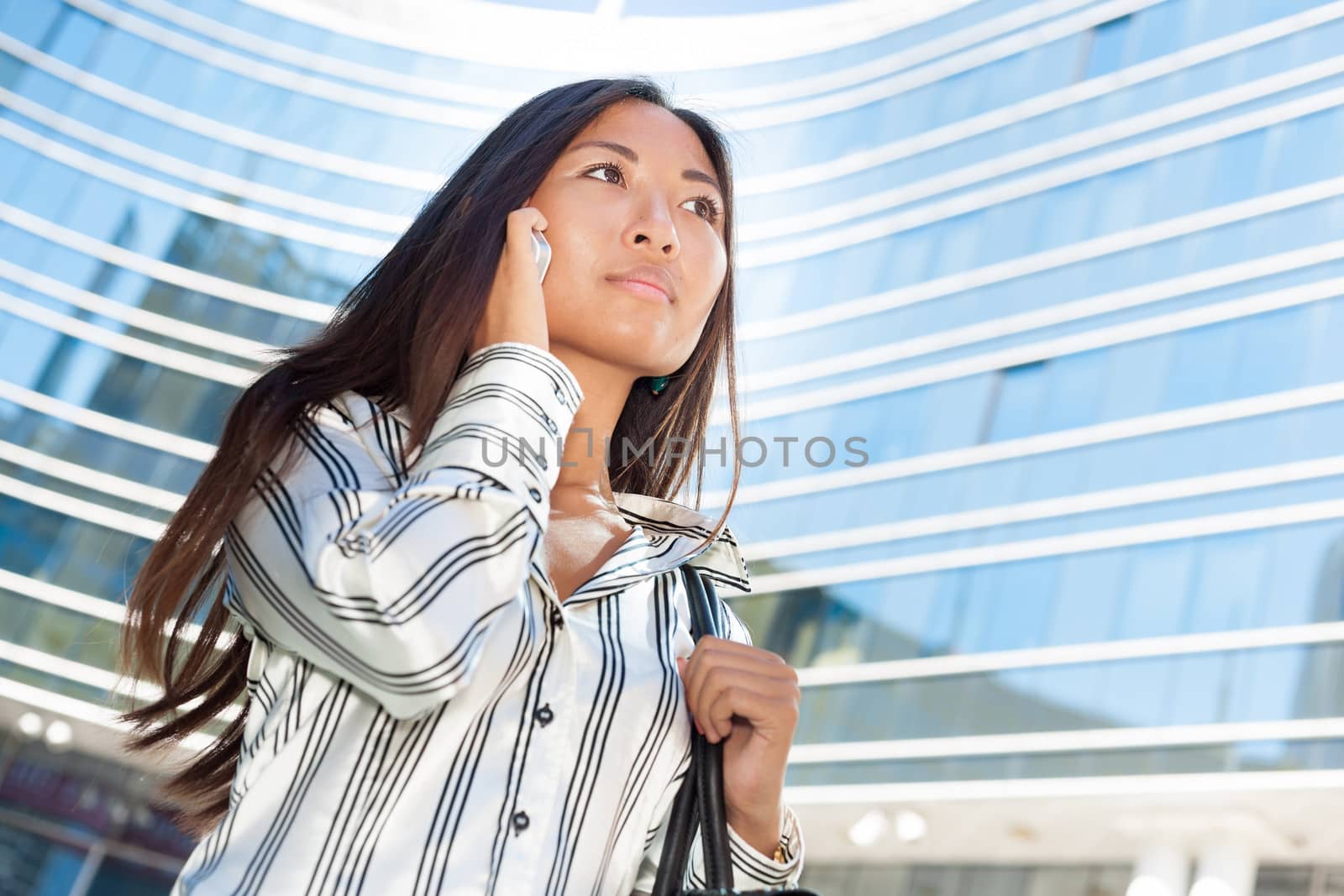 Asian woman walking and phoning by TristanBM