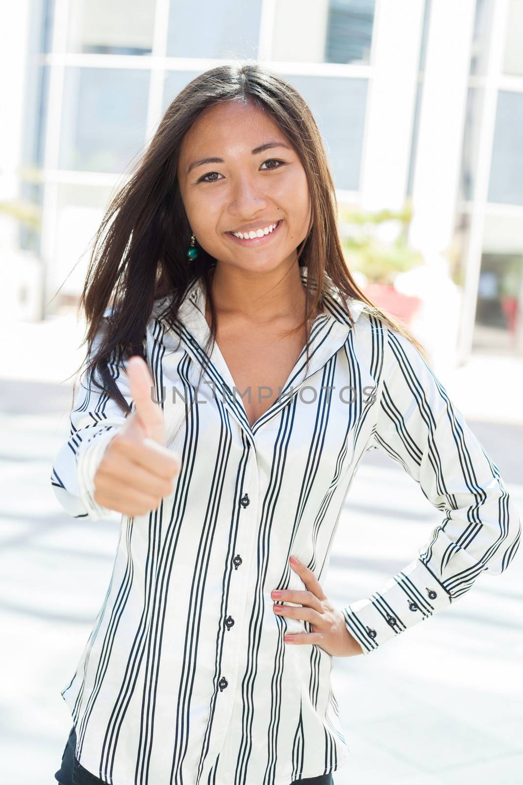 Portrait of a cheerful asian woman with positive gesturing