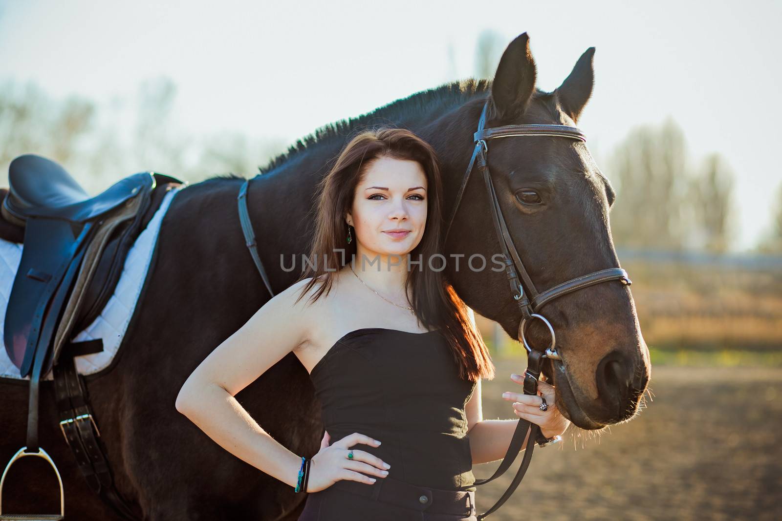 Young woman with a horse on nature