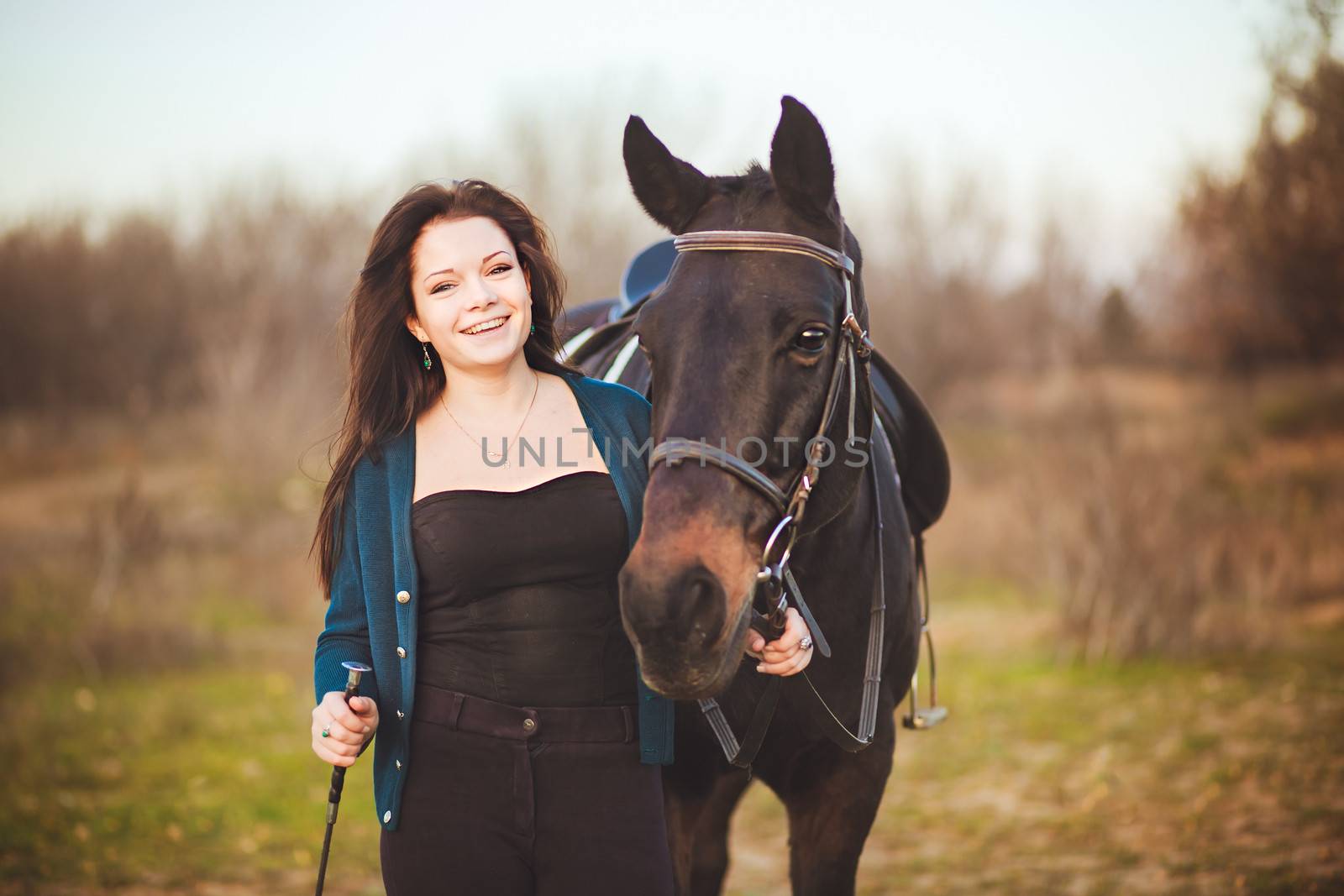 Young woman with a horse on nature