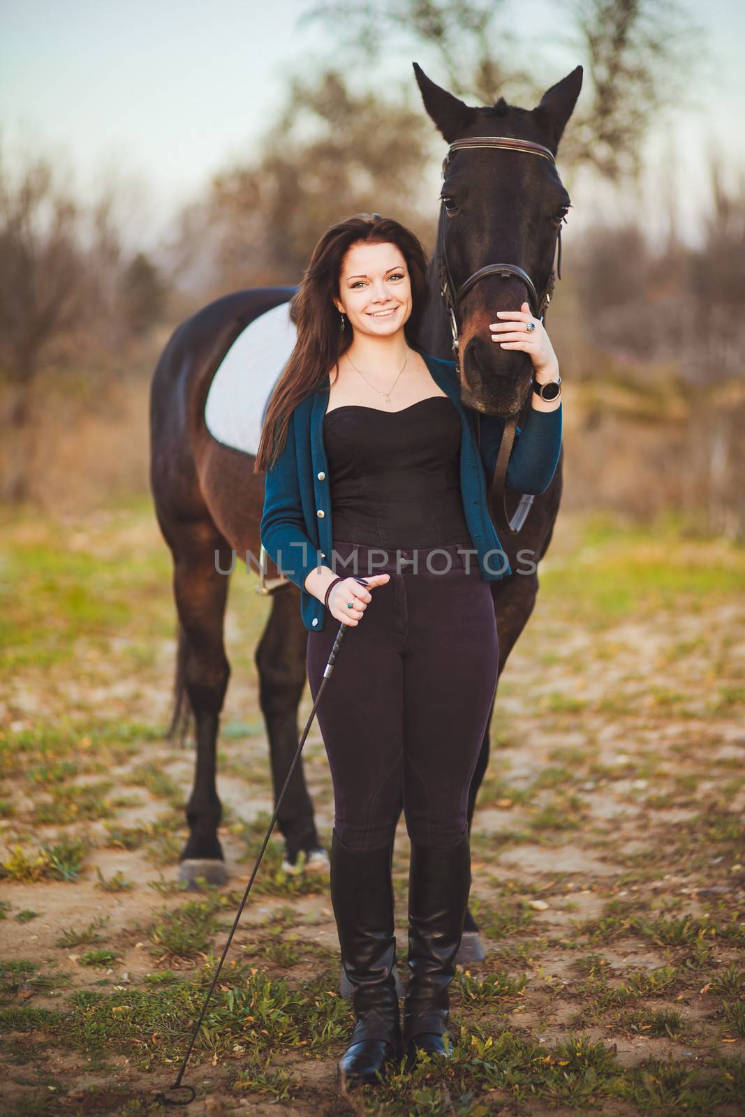 Young woman with a horse on nature