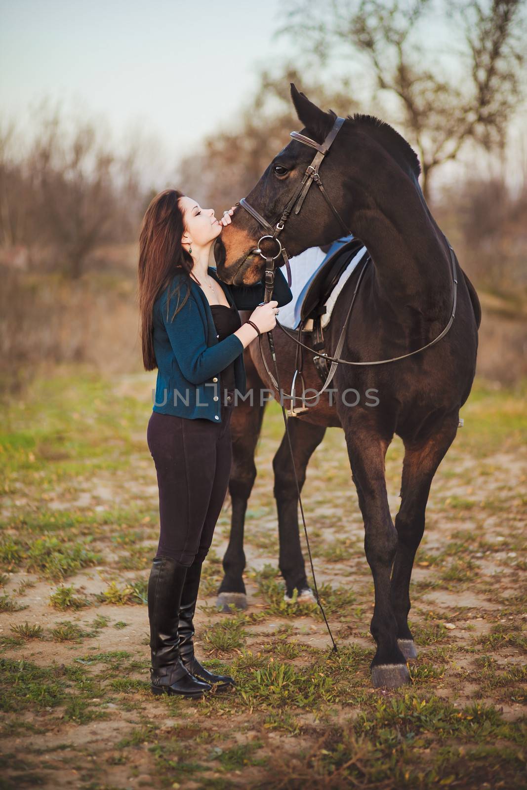 Young woman with a horse on nature