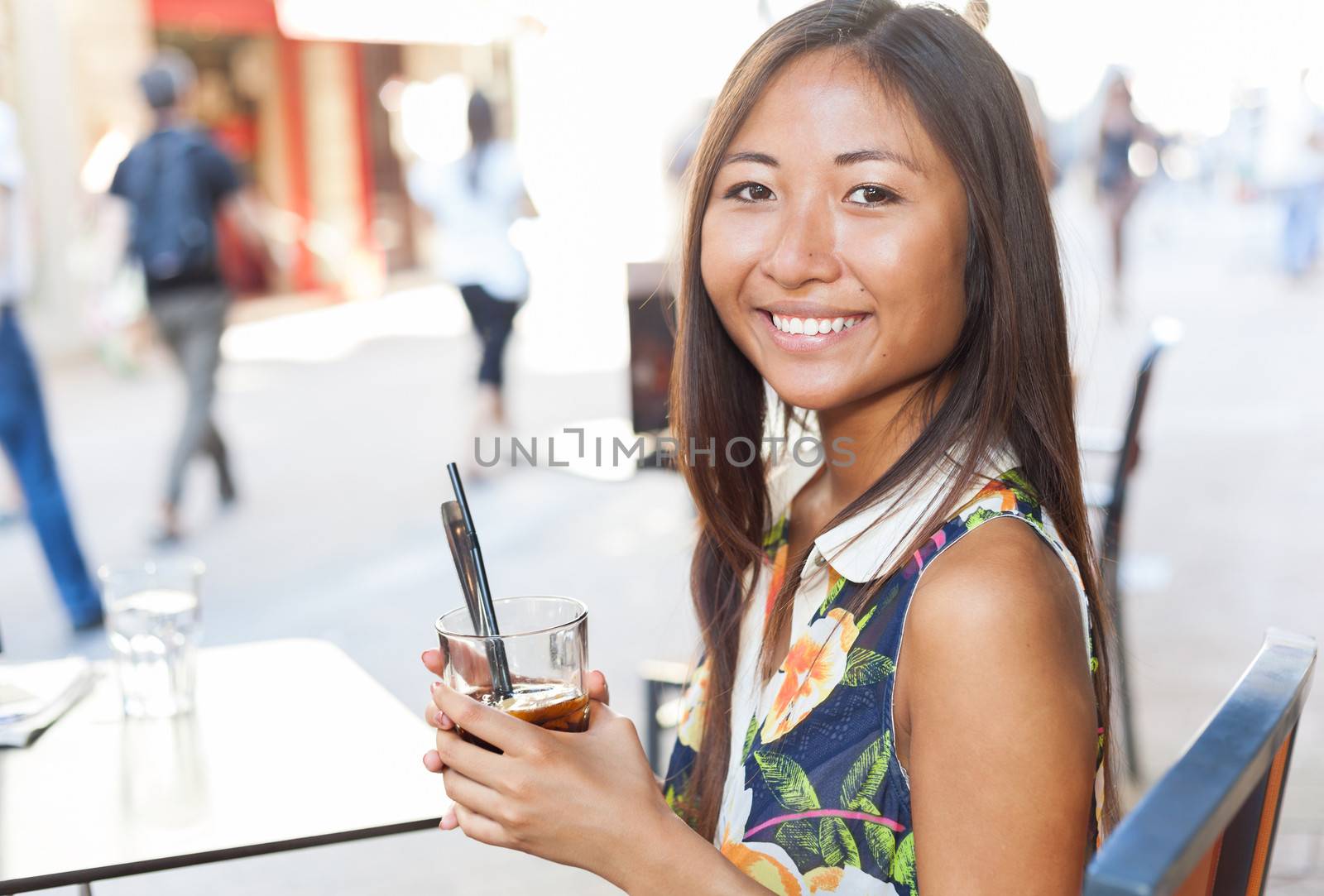 Pretty asian girl drinking on terrace by TristanBM