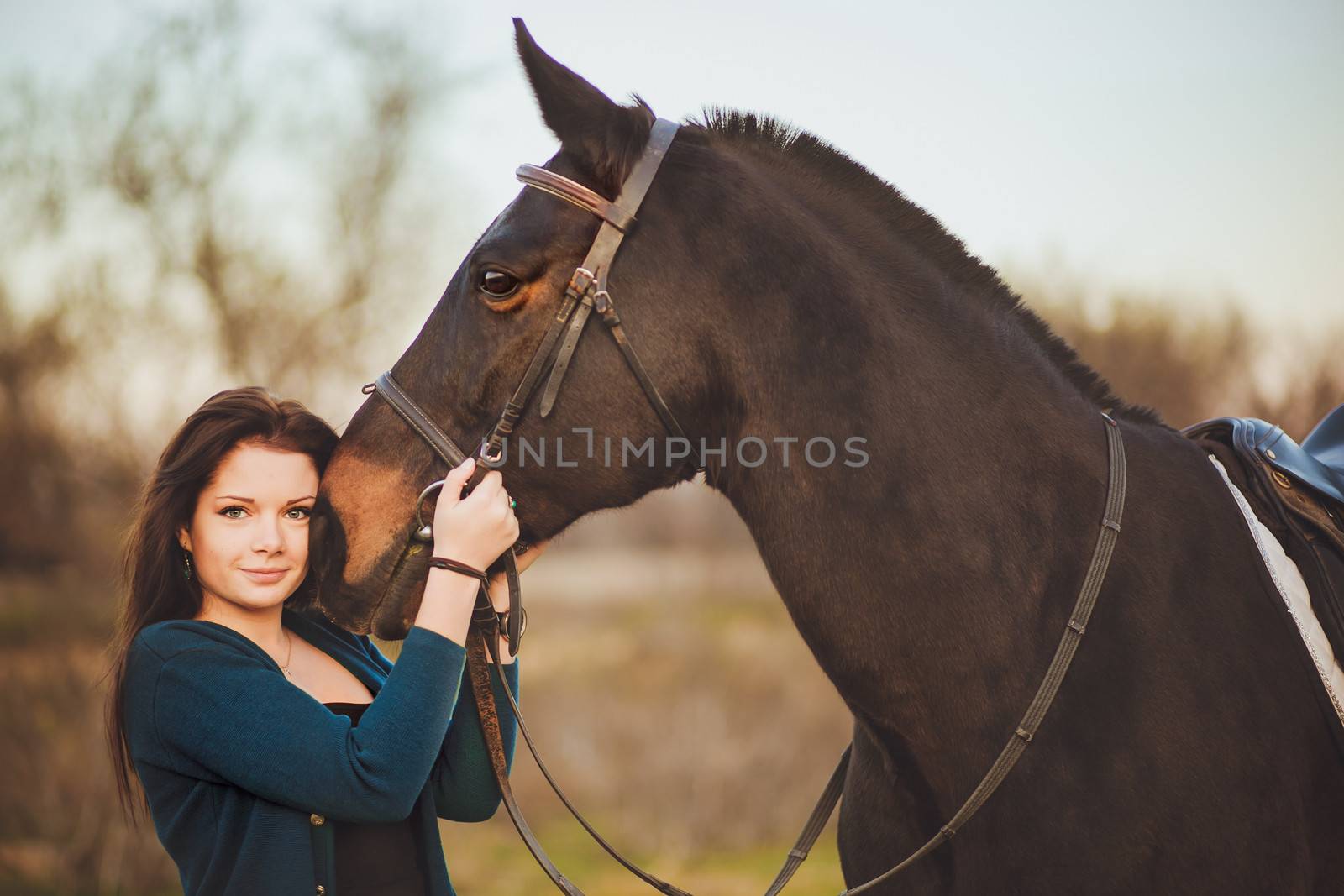 Young woman with a horse on nature