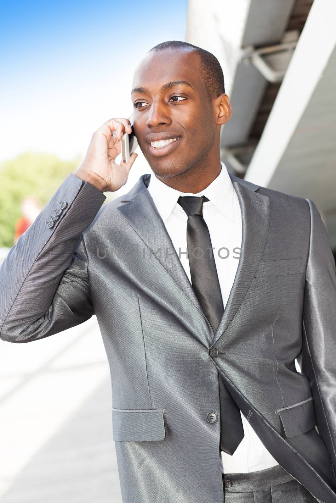 Portrait of an attractive businessman walking and phoning