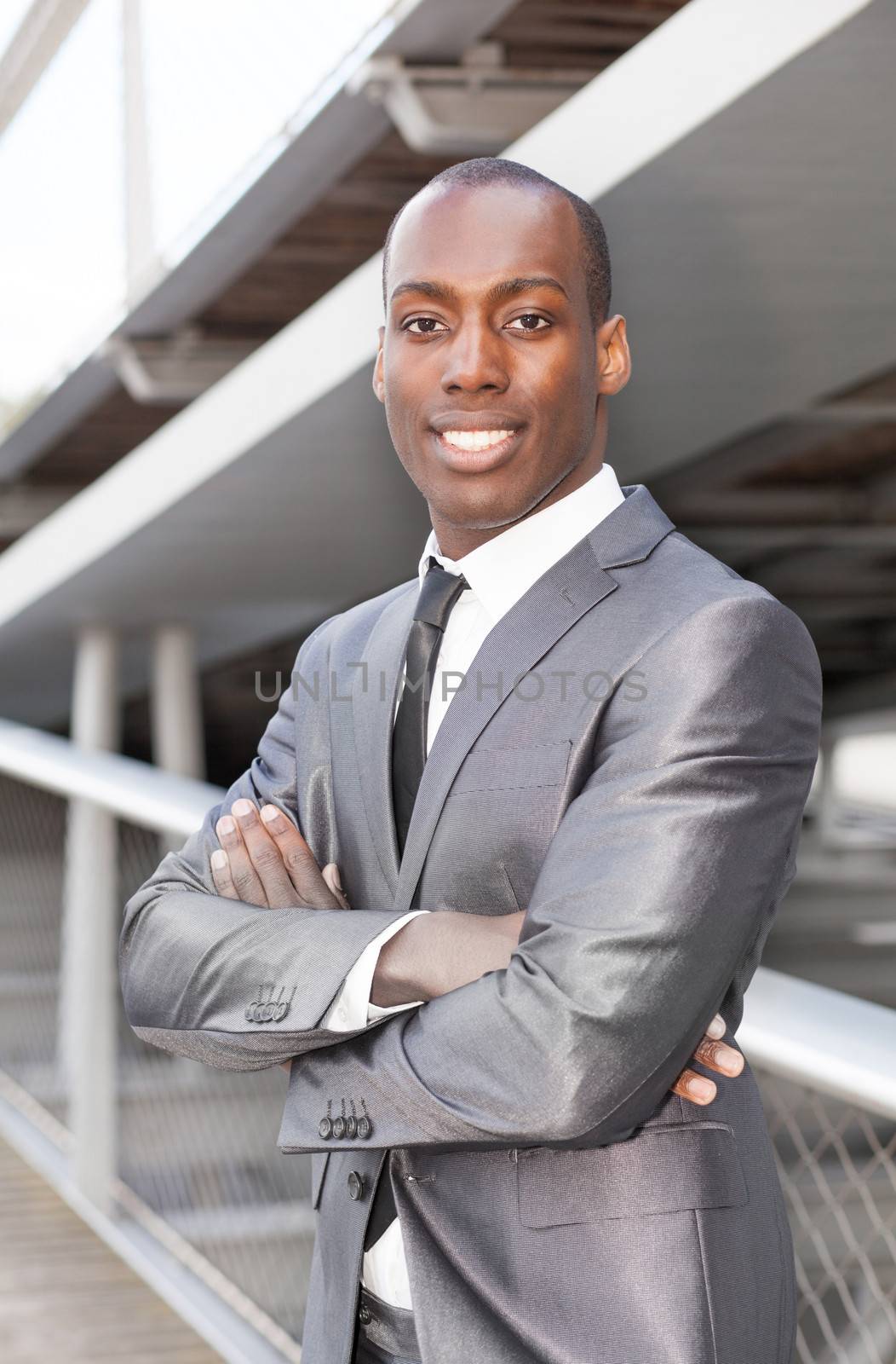 Portrait of a attractive african businessman with arms crossed