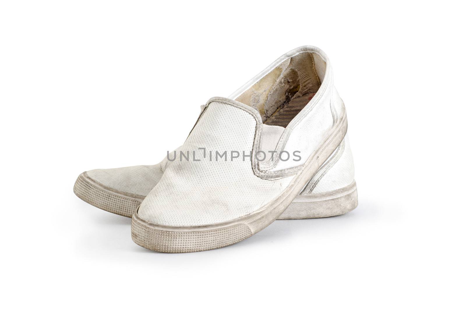 A pair of old dirty sneakers on a white background, isolated