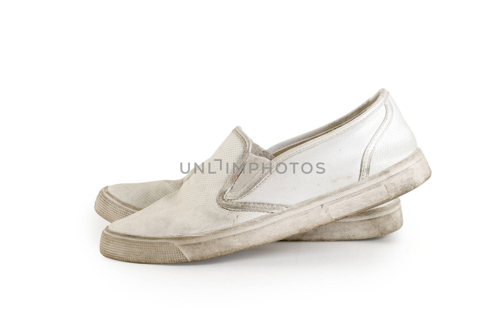 A pair of old dirty sneakers on a white background, isolated