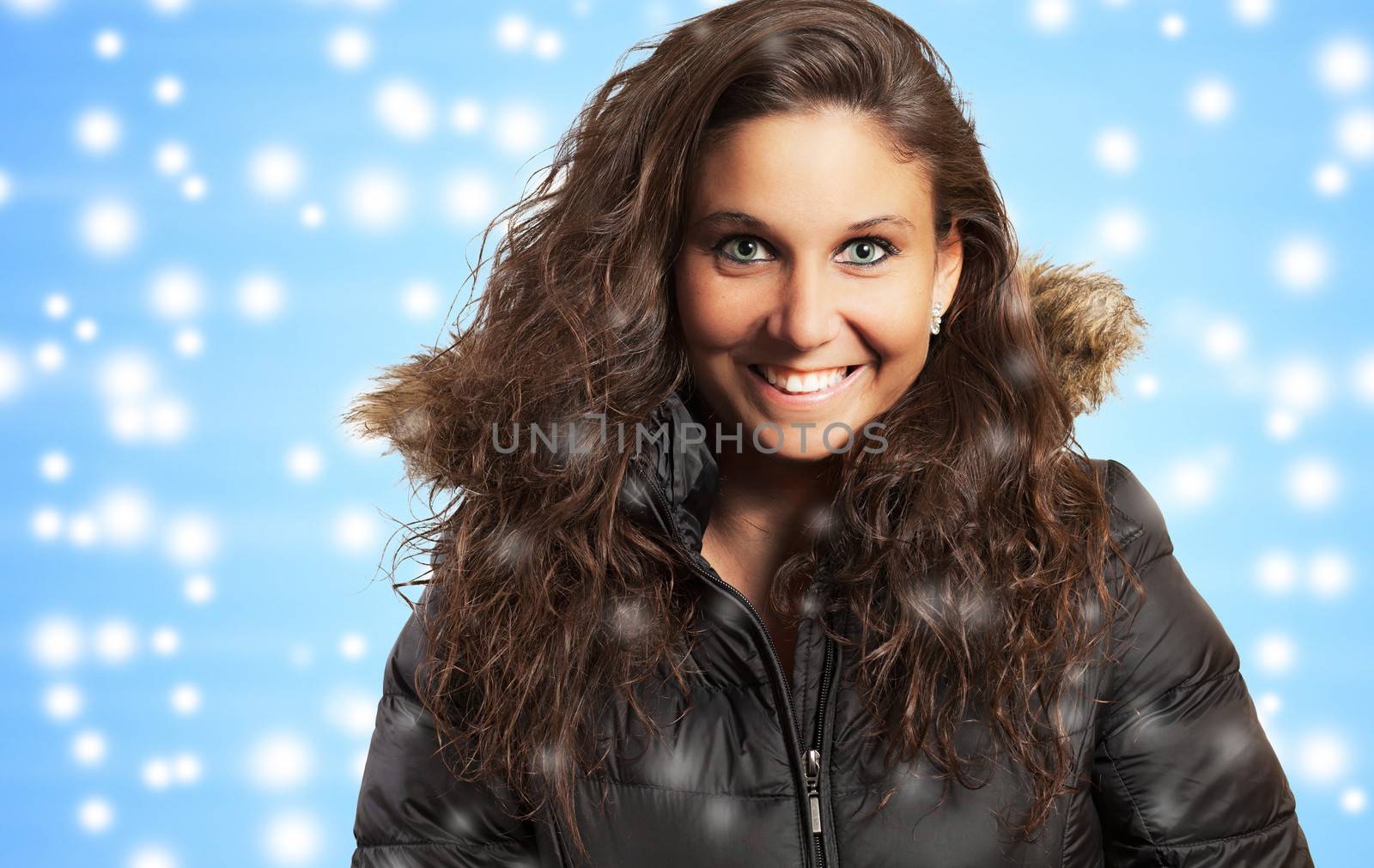 Studio portrait of a nice young woman and winter background