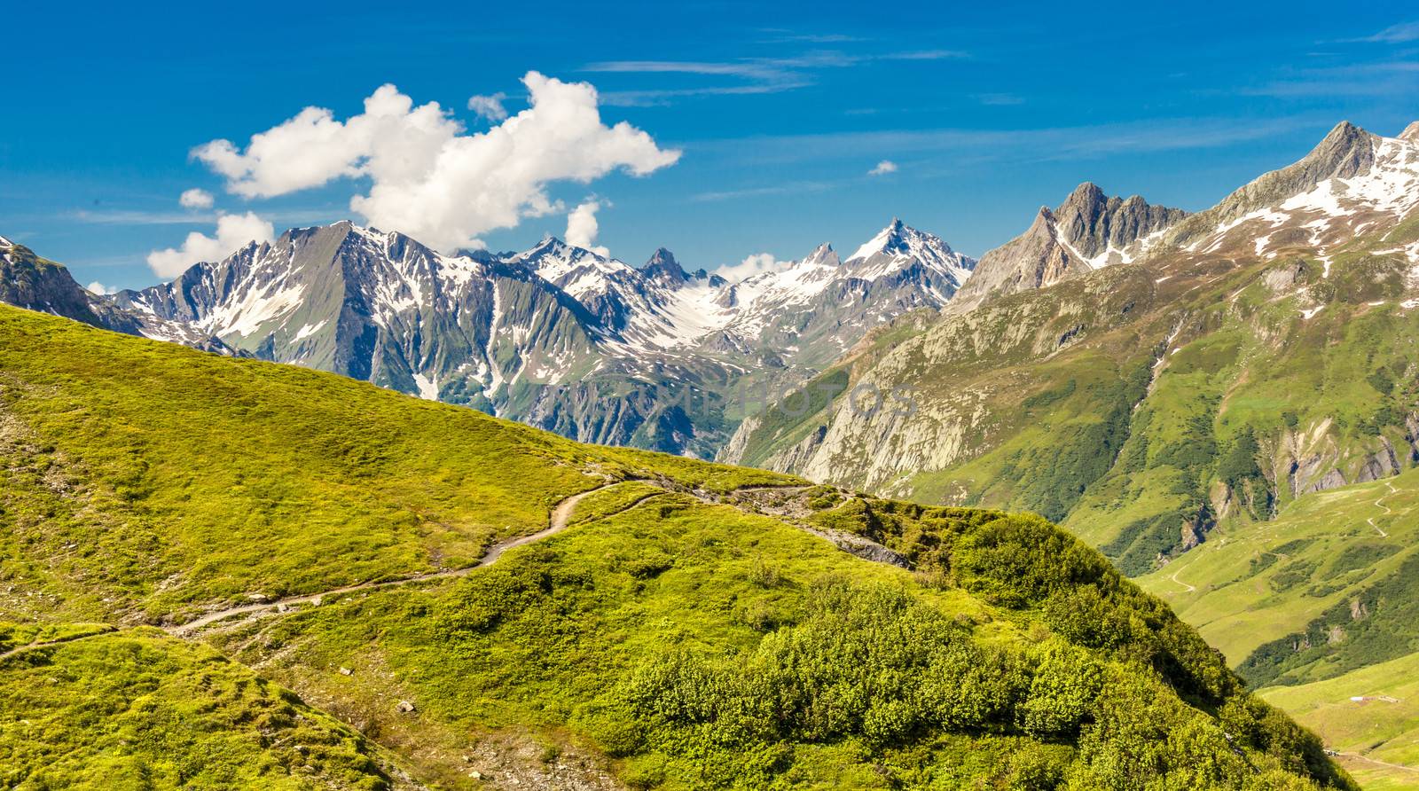 Mountain scenery in the Alps, with a hiking trail in the foreground