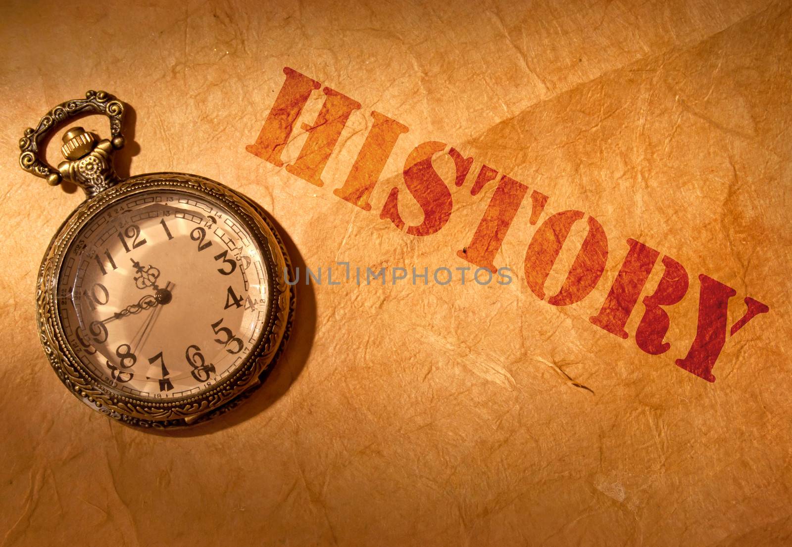 History etched on an old paper scroll with a vintage clock