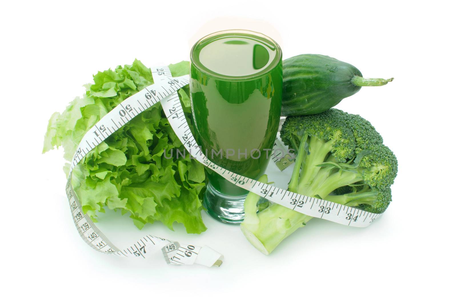 Tape measure wrapped around a refreshing green vegetable juice 