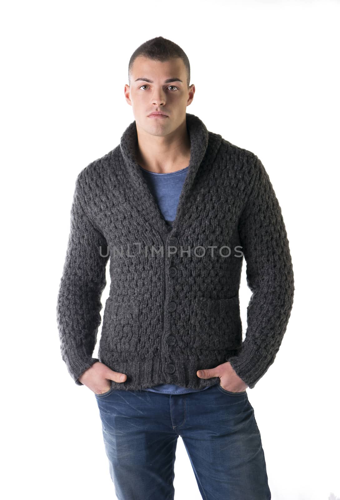 Attractive young man with wool sweater and jeans, isolated on white background