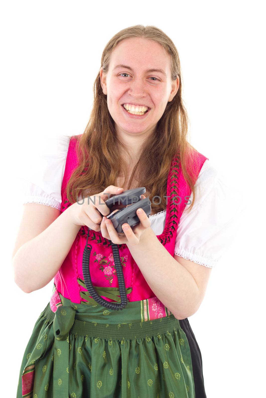 Very happy girl in dirndl hanging up the phone