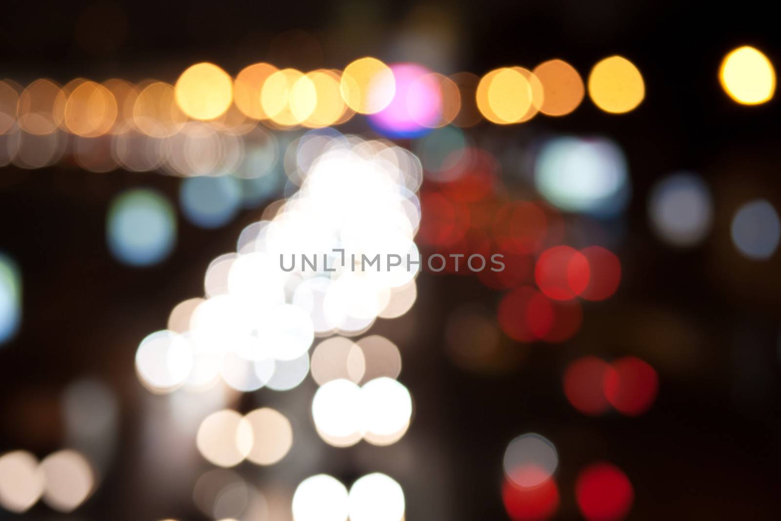 Road at night with traffic trails and blurred lights