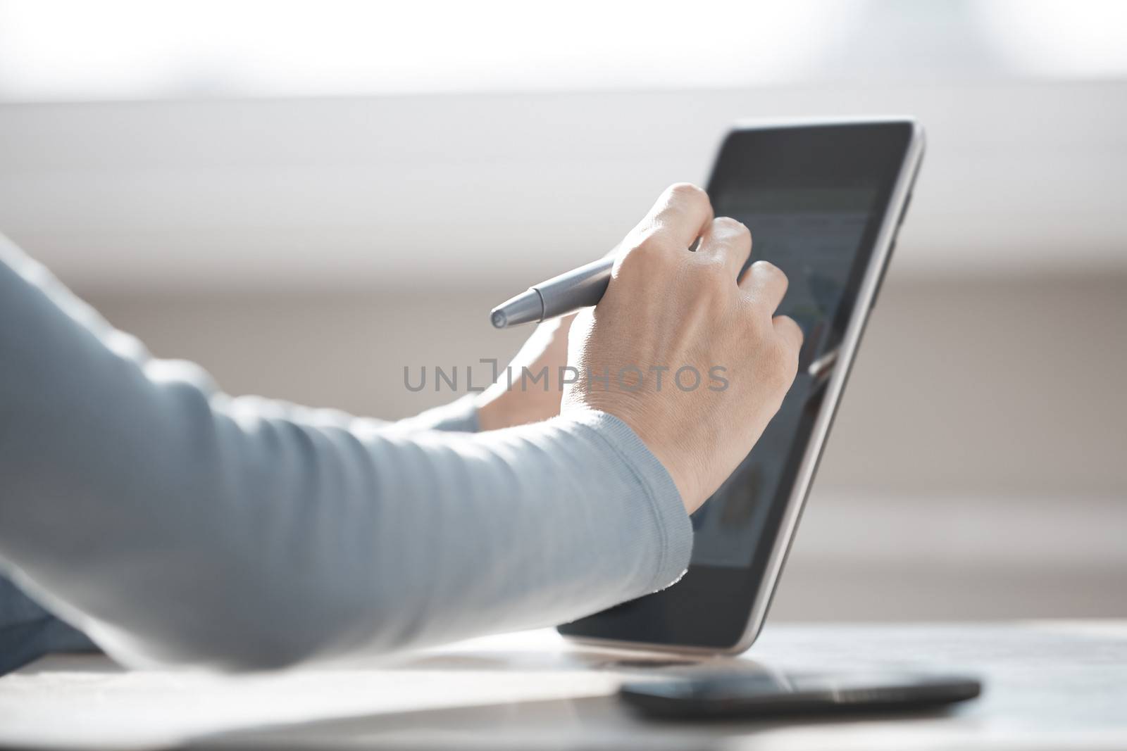 Human hands using tablet PC for Internet surfing