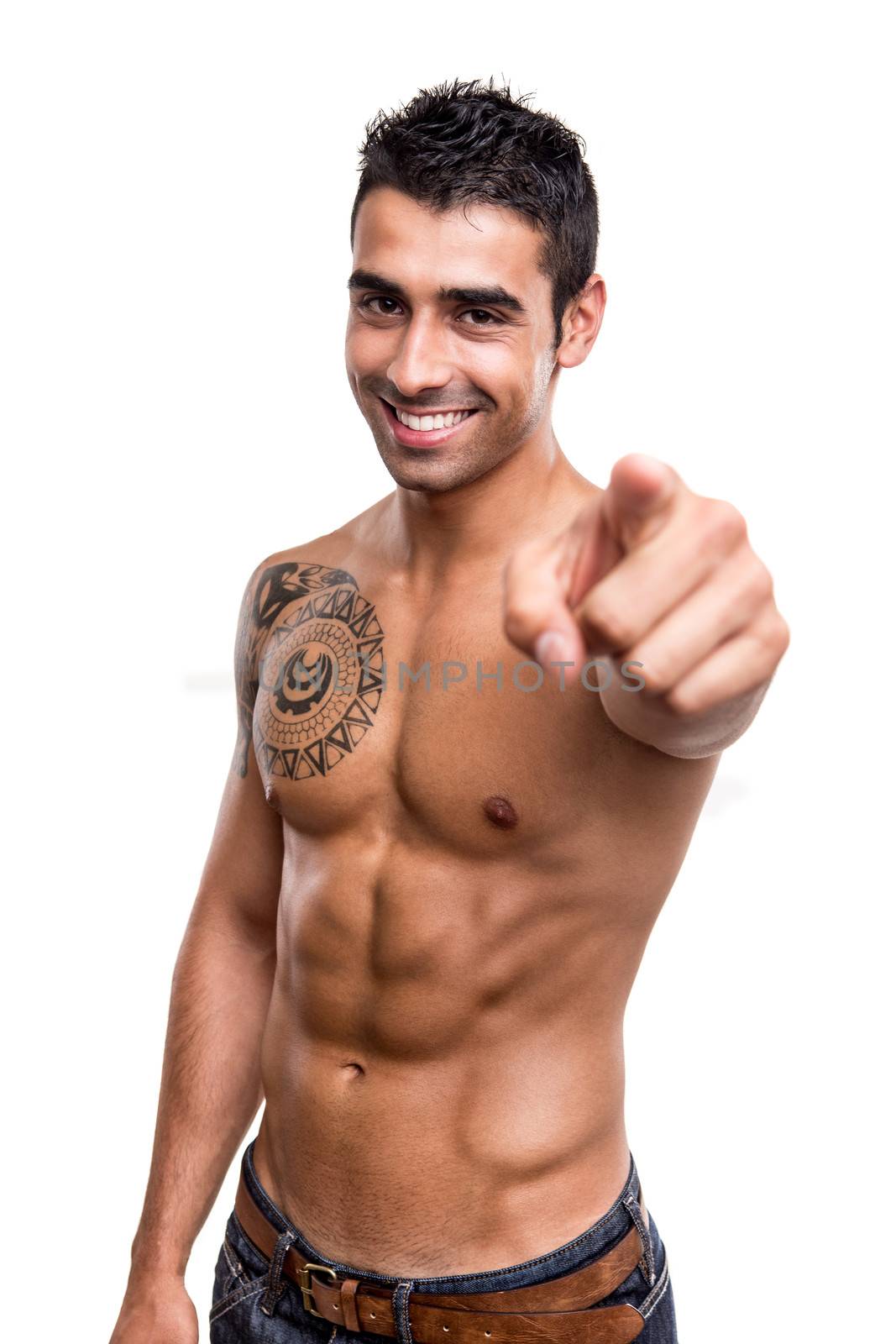 Fit man pointing front over white background