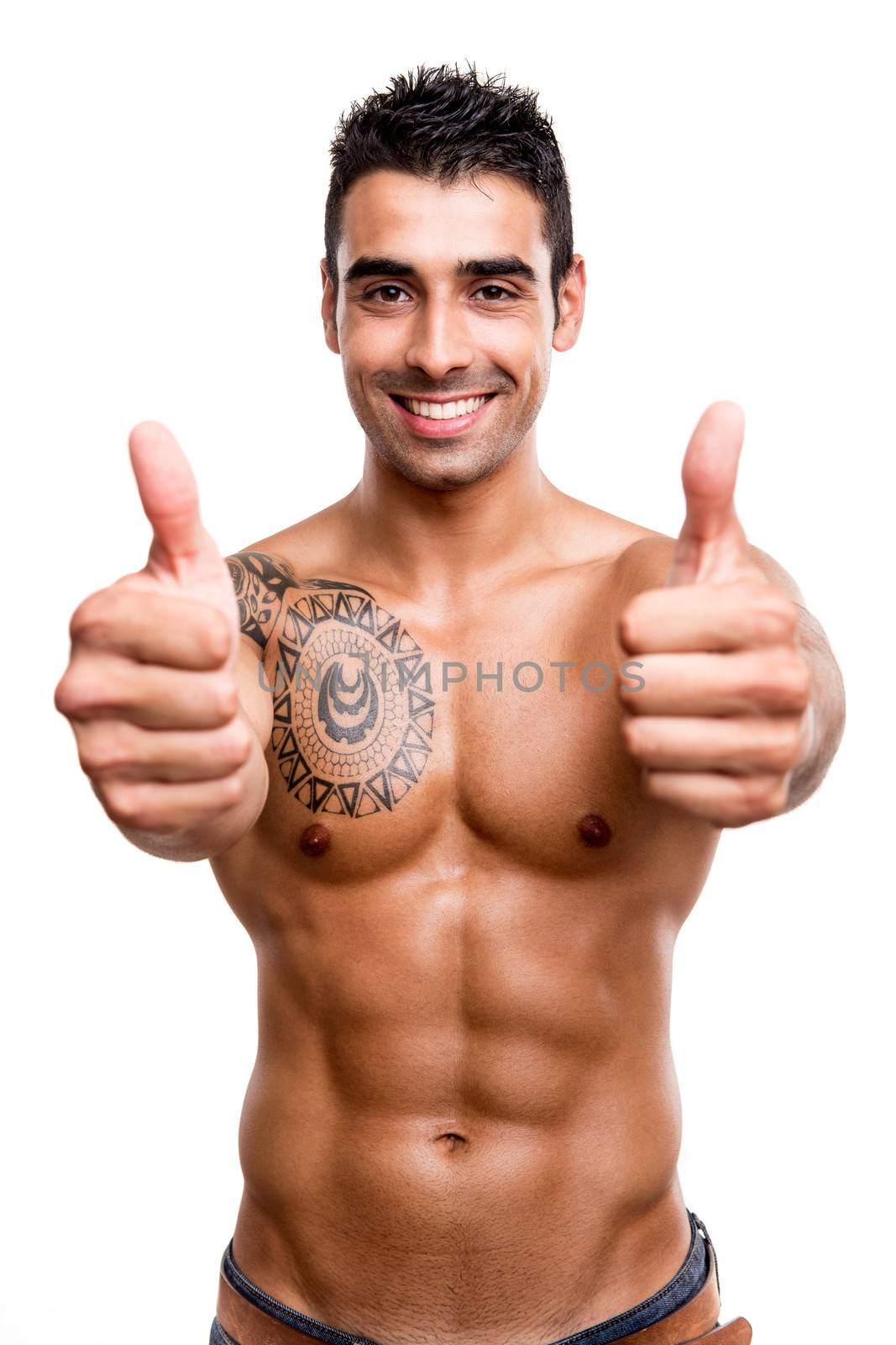 Fit man showing thumbs up over white background