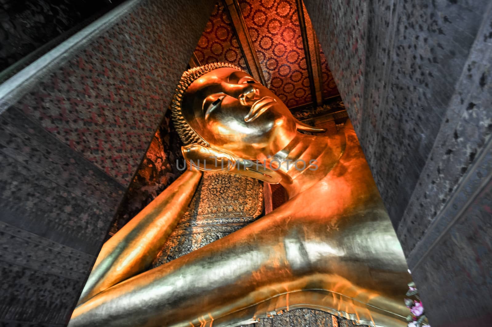 gold Reclining Buddha statue face. Wat Pho, Bangkok, Thailand by weltreisendertj