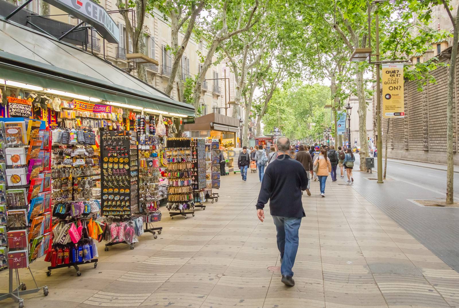 People walking in La Rambla street of Barcelona by doble.d