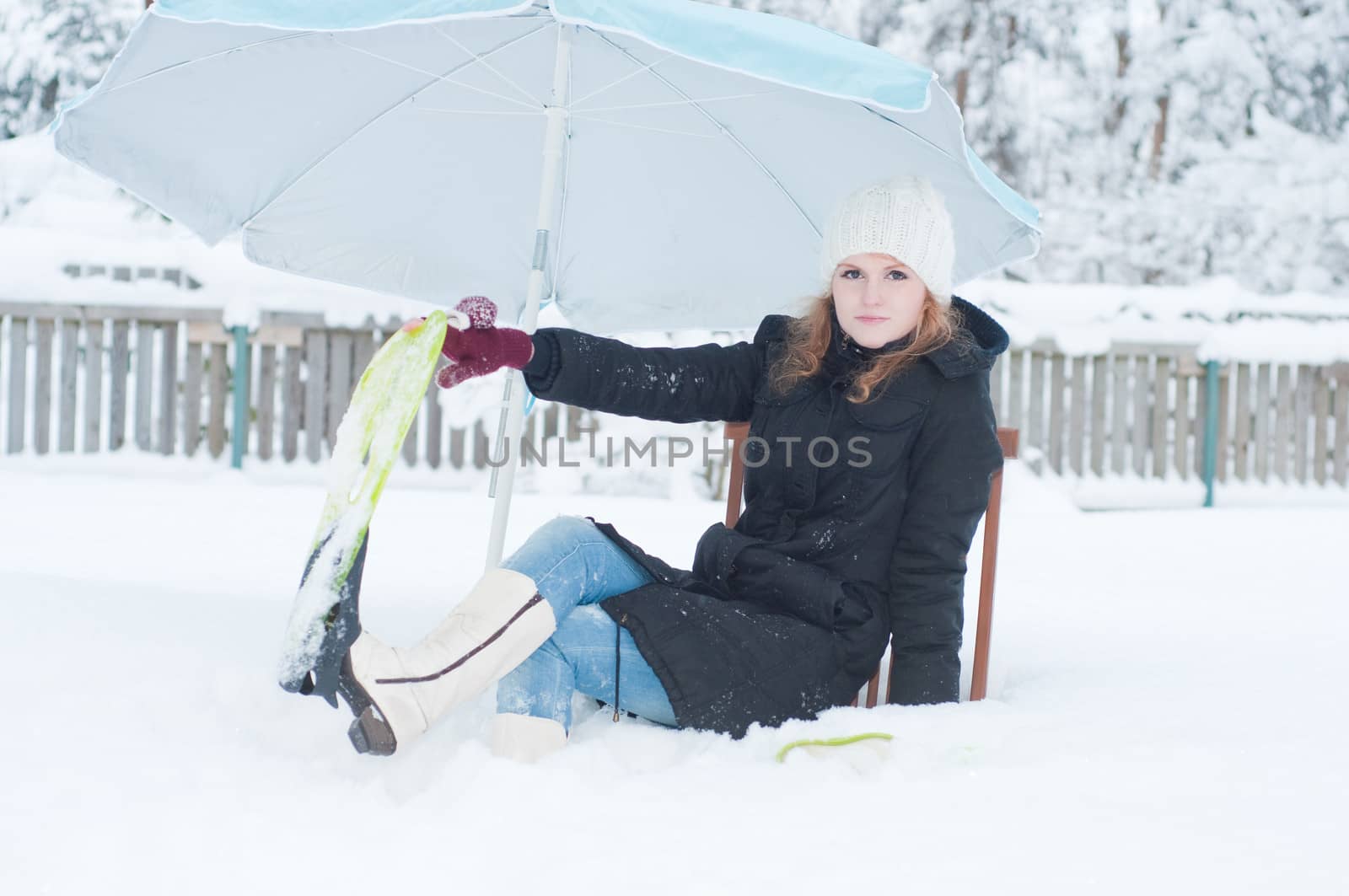 Girl with fins sitting in snow by anytka
