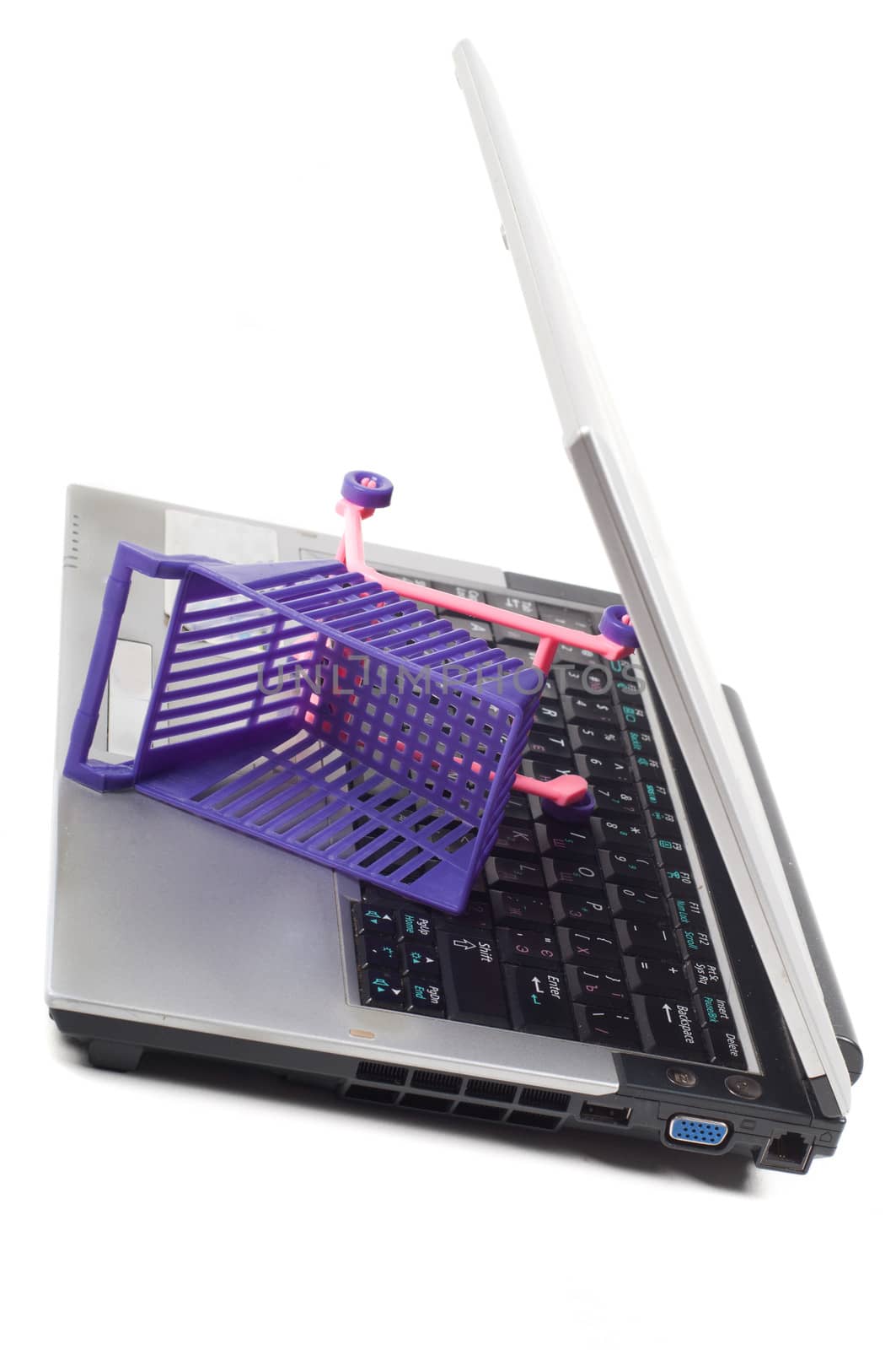 Laptop with a shopping-cart isolated on white