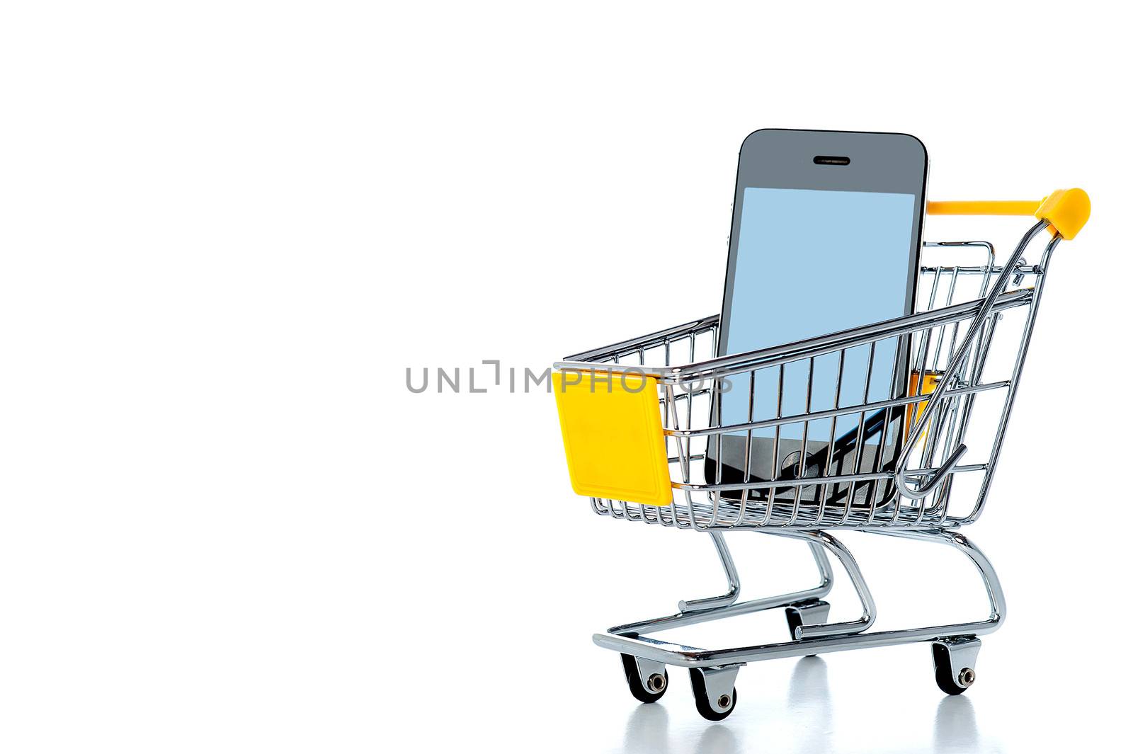 Mobile phone in shopping cart by stockyimages