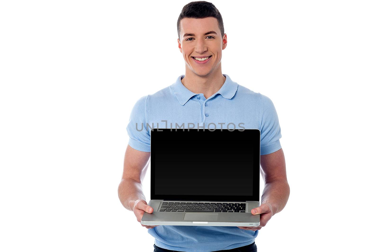 Handsome young man showing his new laptop