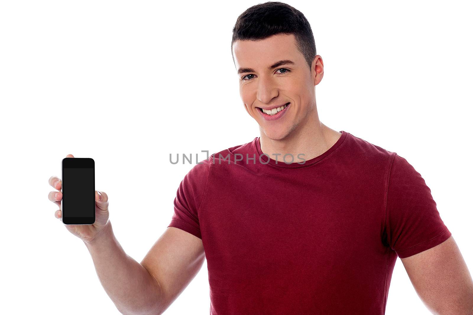 Smiling handsome guy displaying his cell phone to camera