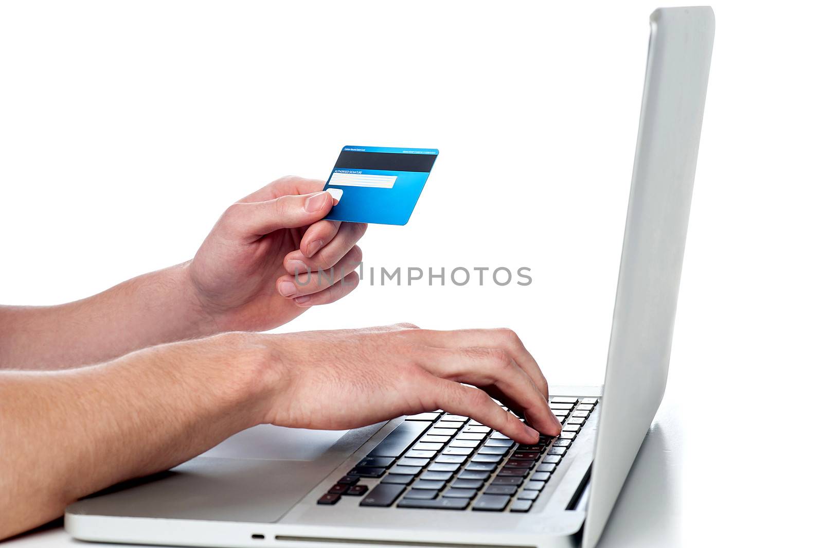 Mans hand  holding credit card and accessing his laptop