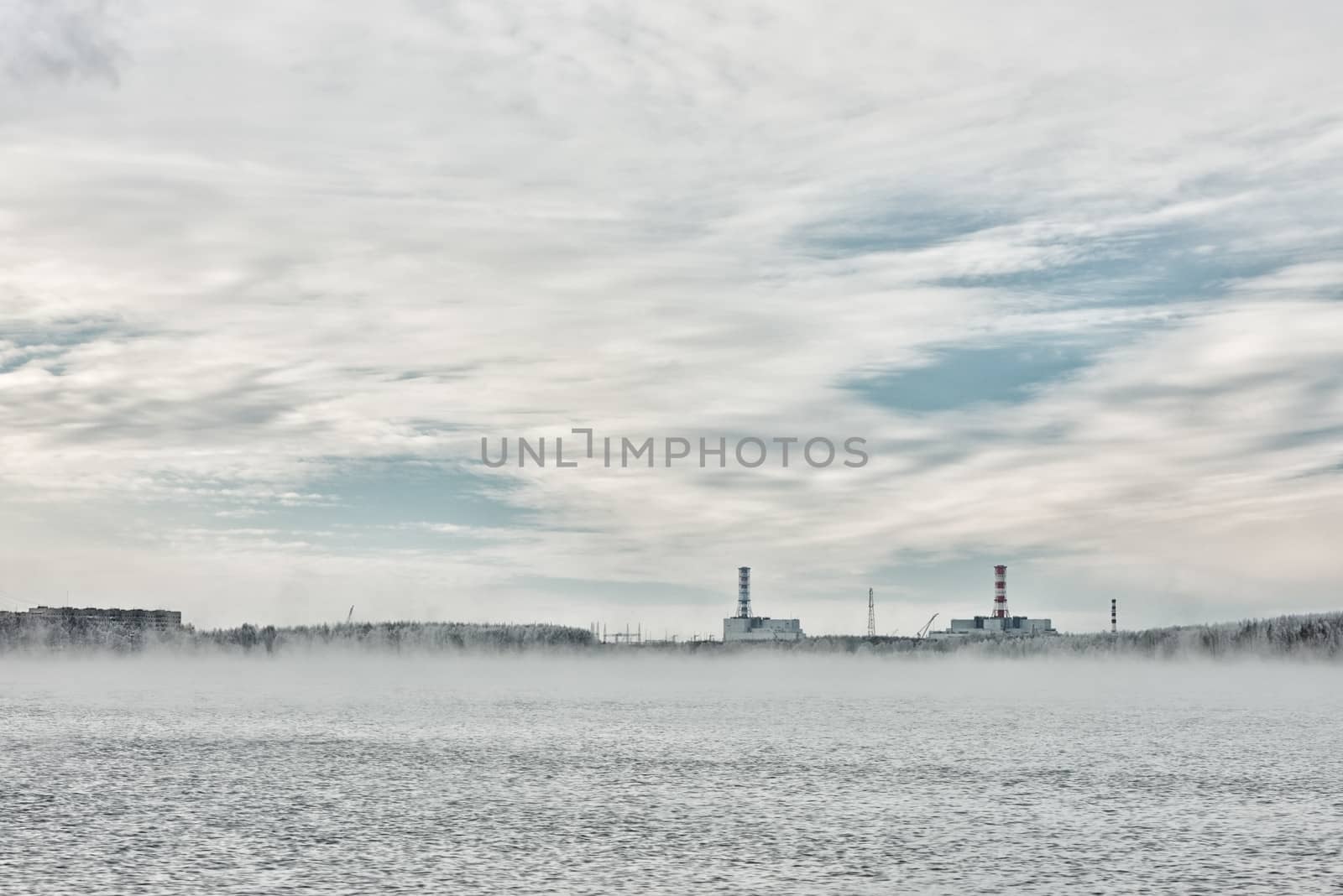 Nuclear power plant on the horizon line in winter by fotooxotnik