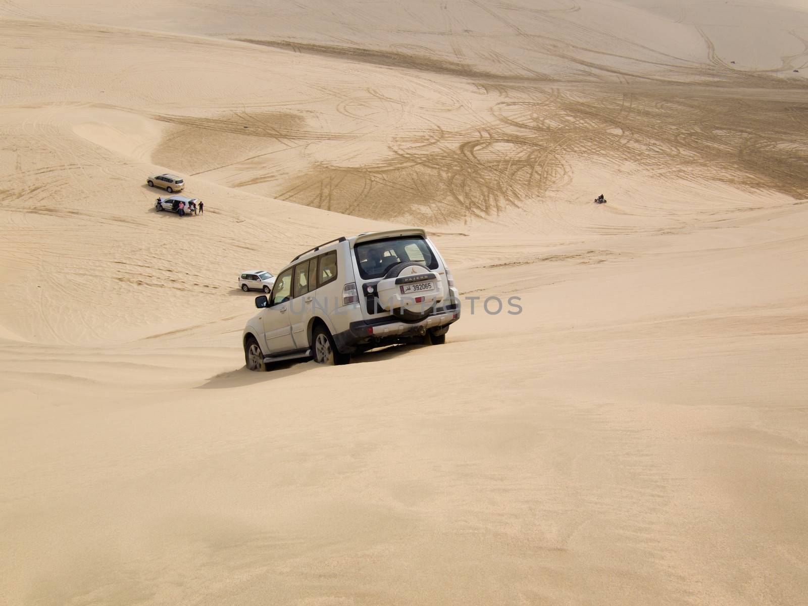 Mesaieed, Qatar – January 10, 2014: 4WD driving on a sand dune in the desert, called dune bashing, in the south of Qatar.