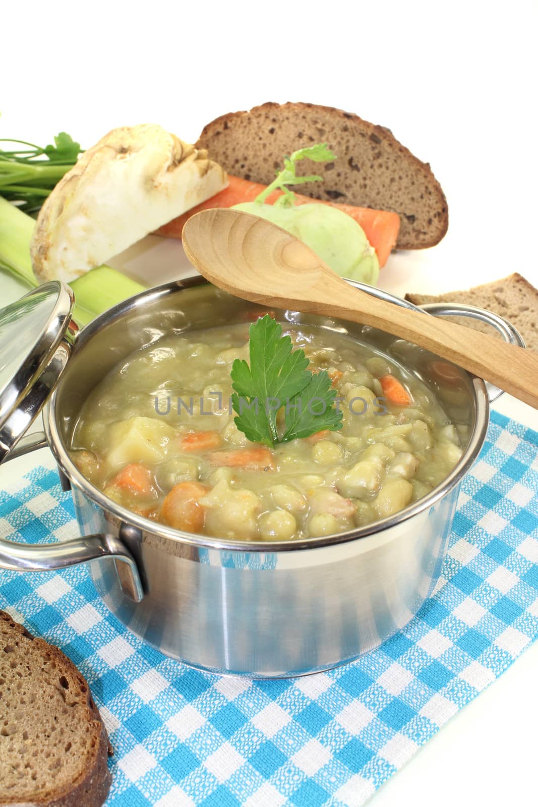 fresh pea stew with carrots on a light background