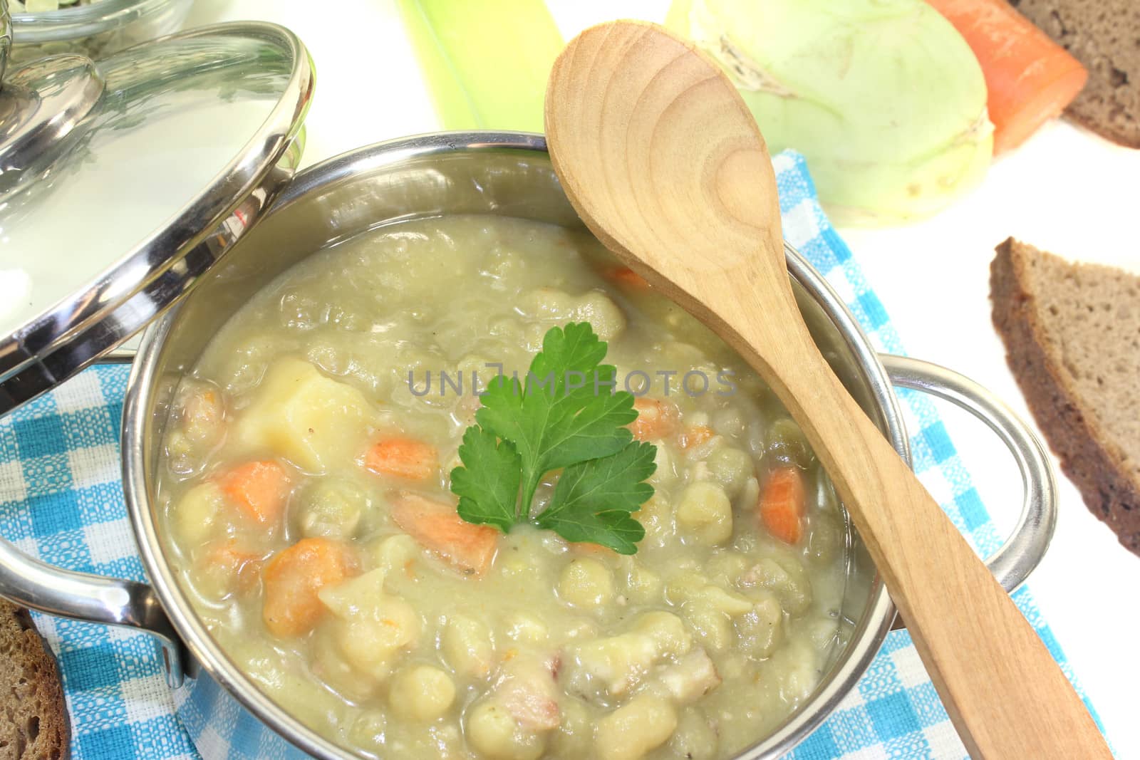 fresh delicious pea stew with potatoes on a light background