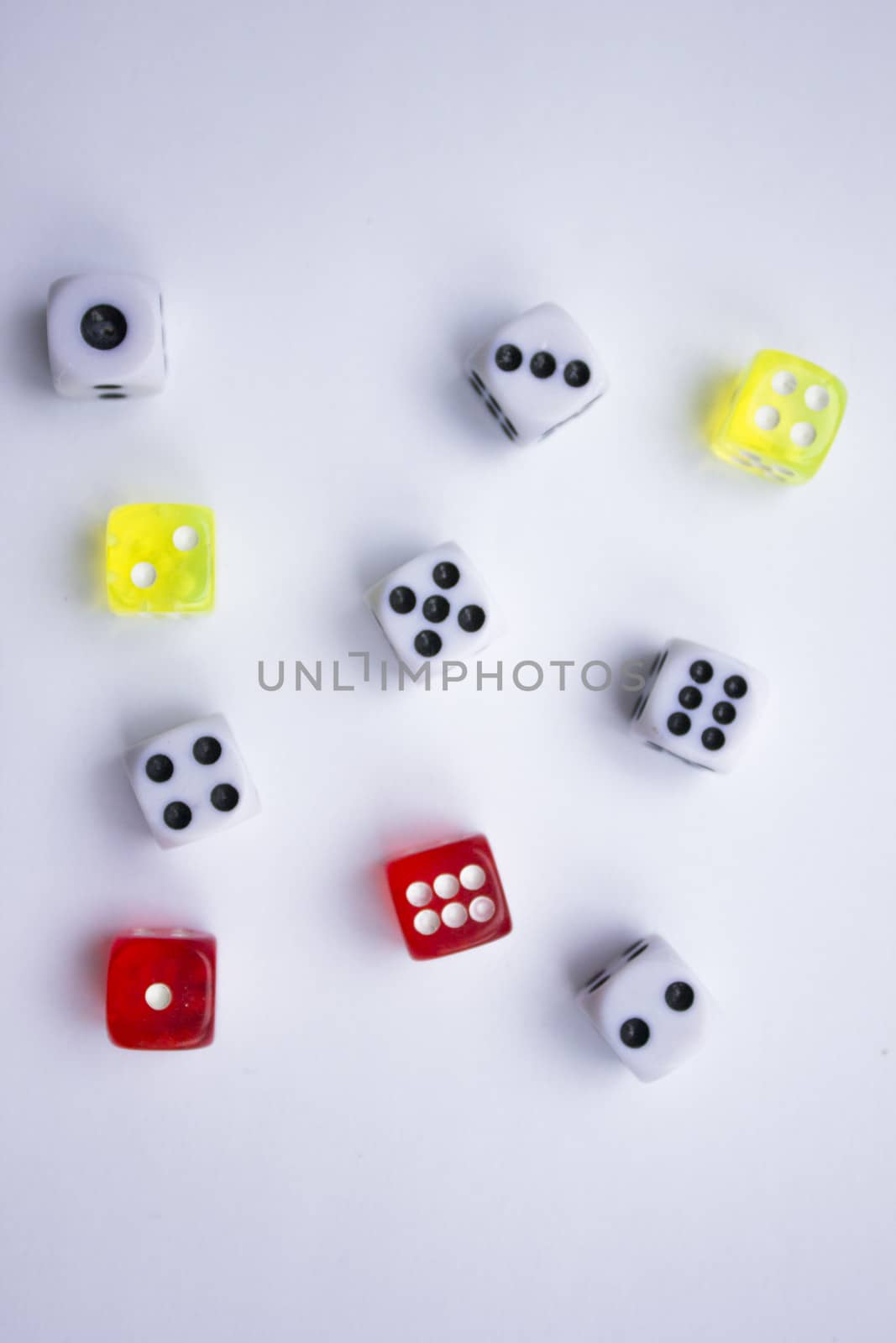 Composition from different colored dice on a white background.